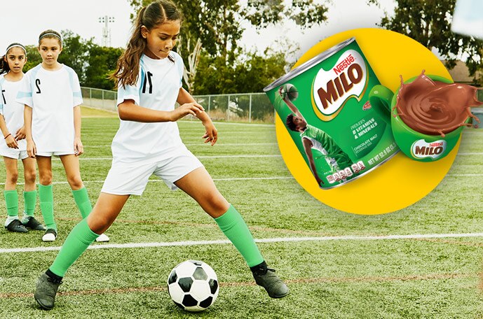 A container and mug of MILO on an image of a young girl dribbling a soccer ball.