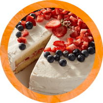 Circle cropped image of berry vanilla bean ice cream cake with layers of pound cake, ice cream, and berries topped with sliced strawberries and blueberries surrounded by an orange textured circle. Circle cropped image of berry vanilla bean ice cream cake with layers of pound cake, ice cream, and berries topped with sliced strawberries and blueberries surrounded by an orange textured circle.