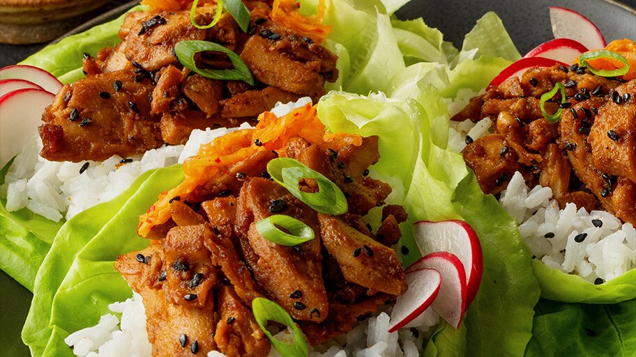 Korean BBQ Lettuce Wraps garnished with green onions, sesame seeds and sliced radish.