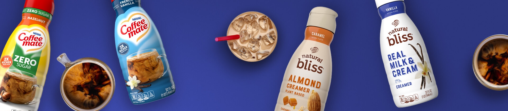 Mugs and glasses of coffee and creamer between bottles of natural bliss and Coffee mate creamers on a blue background.