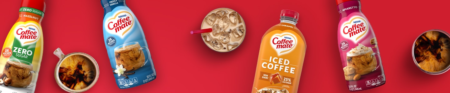 Iced Coffee, Zero Sugar Hazelnut, French Vanilla, & Amaretto Creamers next to coffee drinks on a red surface.