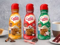 Bottles of Peppermint Mocha, Frosted Gingerbread Mocha, and Pumpkin Spice creamers next to cake, coffee, and peppermints.