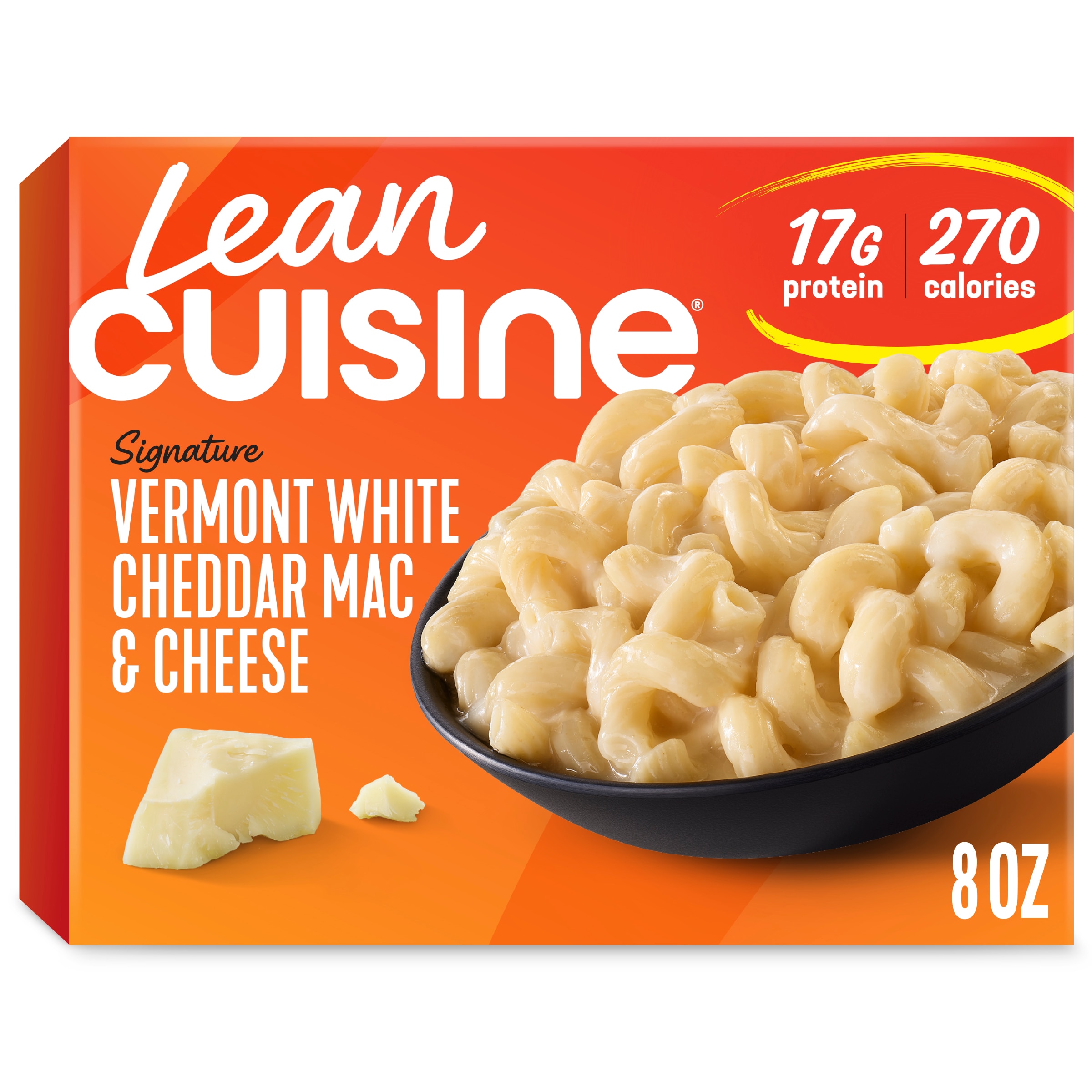 A box of Vermont White Cheddar Mac and Cheese with a Protein Kick label near a bowl of macaroni with Vermont cheddar sauce.