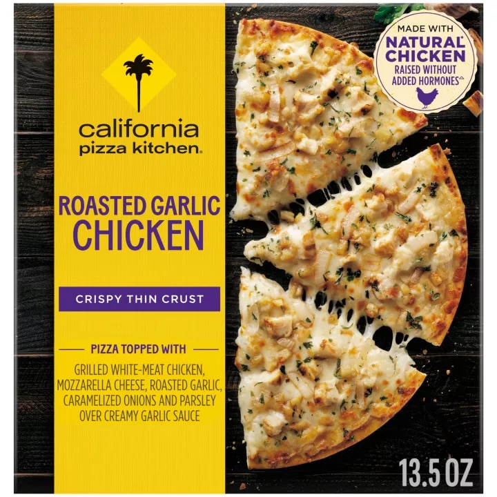 Box of Roasted Garlic Chicken Pizza with half a pizza, chicken and the natural chicken badge on a black wooden surface.