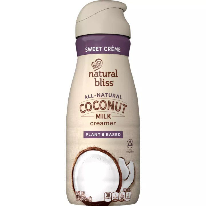 Una botella beige de creamer Coconut Sweet Creme de natural bliss con una etiqueta morada encima de un coco y el logotipo del producto.