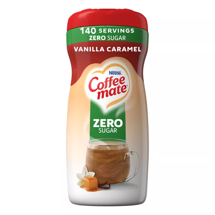 Una lata de creamer en polvo Coffee mate Vanilla Caramel con una taza de café y caramelo derretido debajo de una etiqueta verde que dice "Sin azúcar".
