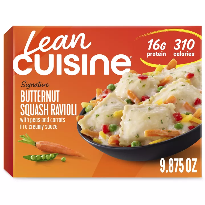 A box of Butternut Squash Ravioli with a Protein Kick label near a bowl of squash ravioli, snap peas, peppers, and carrots.