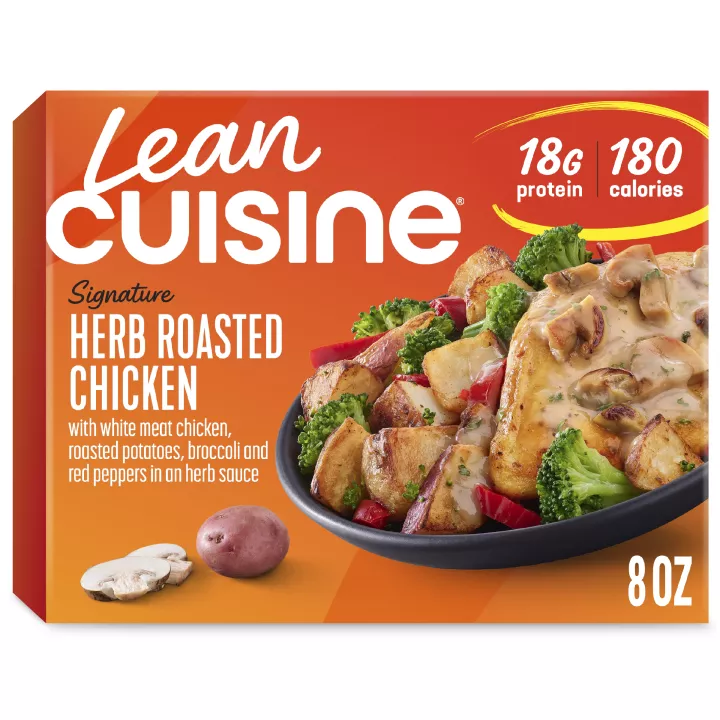 A box of Herb Roasted Chicken with a Protein Kick label near a bowl of chicken with mushroom sauce, broccoli, and potatoes.