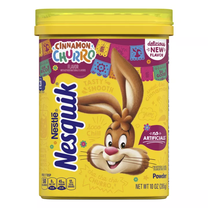 Container of NESQUIK Cinnamon Churro powder with the Nesquik bunny, Mexican party decorations and a No Artificials badge.