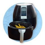 Close up of an open air fryer, on a blue background.