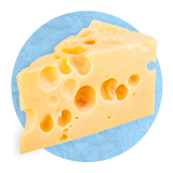 Close up of a wedge of Swiss cheese, on a blue background.