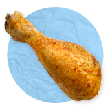 Close up of a roasted chicken drumstick, on a blue background.