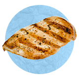 Close up of a grilled chicken breast, on a blue background.