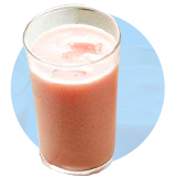 A glass filled with strawberry bliss aguas frescas on a light blue circle. 