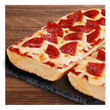 Pepperoni French bread pizza on a granite slate and wooden table top.