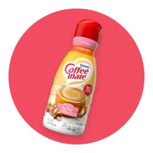 Ícono circular rosado con una botella de creamer Coffee mate® sin grasa.
