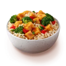 General Tso Tofu over brown rice in a white bowl.