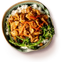 Overhead of a bowl of sweet earth plant-based chik'n & broccoli over white rice.