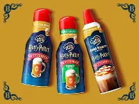 three themed coffee creamer bottles on gold background with ornate corner flourishes