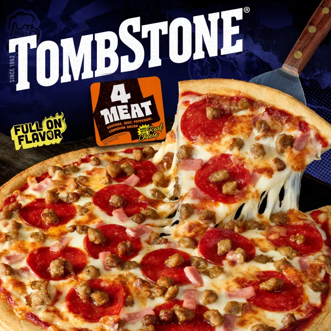 Package of original 4 meat pizza with an orange label and border, a spatula under a pizza, and the Tombstone logo with a Quarter Pound of Cheese and Bold and Zesty Sauce badge.