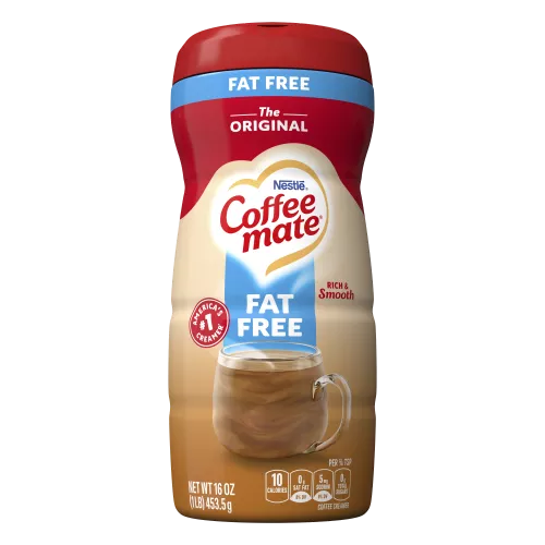 A canister of Coffee mate Fat Free Original Powder with a red cap and blue label above a mug of coffee with biscotti.
