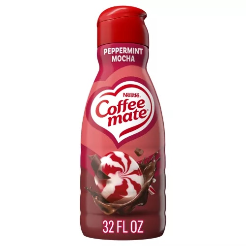 A red bottle of Peppermint Mocha Creamer with a coffee mug, chocolate chunks and peppermint bits under the Coffee mate logo.