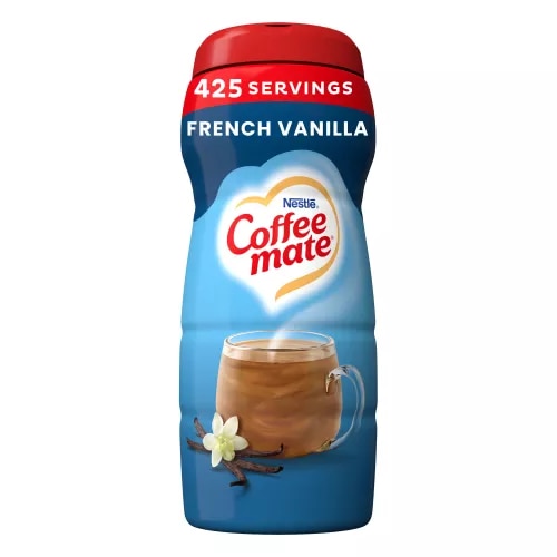 A blue canister of Coffee mate French Vanilla Powder with a red cap above a mug of coffee and vanilla beans.