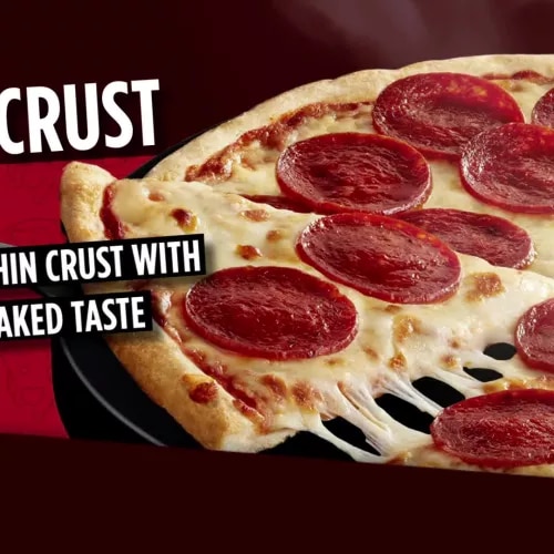 A box of Gluten Free Pepperoni Pizza with New & Improved Recipe, No Wheat Ingredients and 100% Real Cheese labels.