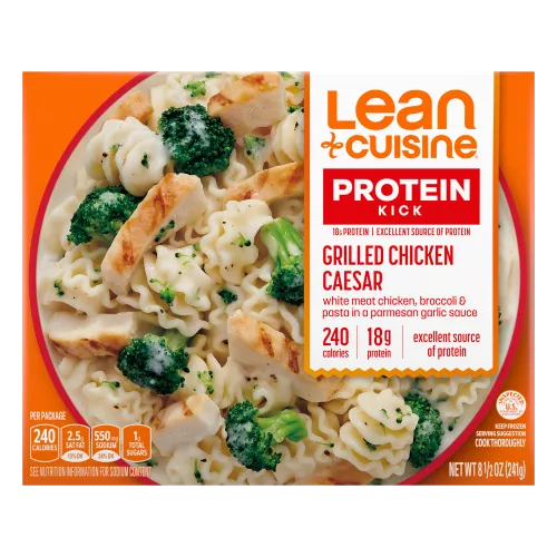 A box of Grilled Chicken Caesar with a Protein Kick label near a bowl of chicken, pasta, broccoli and a parmesan Caesar sauce.