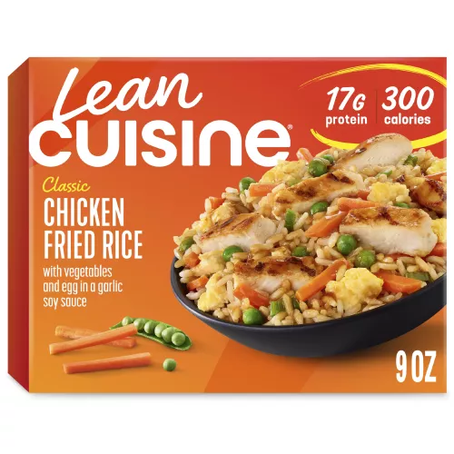 A box of Chicken Fried Rice with a Comfort Cravings label near a bowl of rice with chicken, carrots, peas, and scrambled eggs.