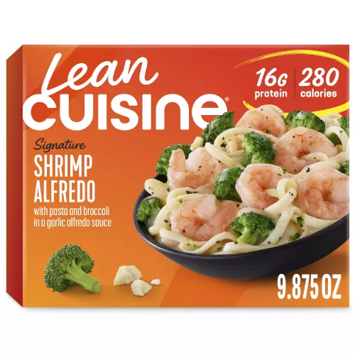 A box of Shrimp Alfredo with Protein Kick label with 280 calories, 16 grams of protein and half cup of veggies near a bowl of shrimp, broccoli, pasta, with Alfredo sauce.