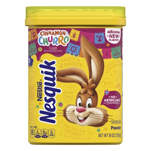 Container of NESQUIK Cinnamon Churro powder with the Nesquik bunny, Mexican party decorations and a No Artificials badge.