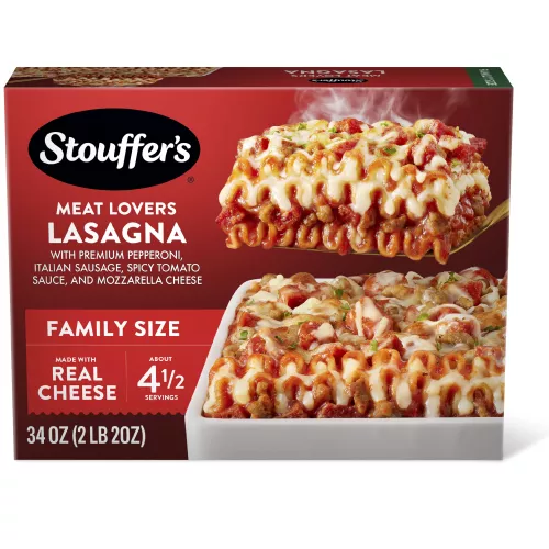 Box of Meat Lovers Lasagna with a plate of lasagna near a dish, the product name, STOUFFER'S logo and "FAMILY SIZE" label.