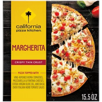 Box of Margherita Pizza with half a pizza, tomato, mozzarella, and basil on a black wooden surface.