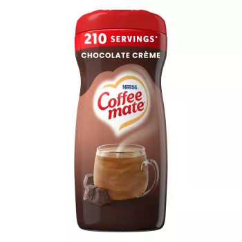 Una lata marrón con creamer en polvo Creamy Chocolate con una pila de brownies debajo del logotipo de Coffee mate.
