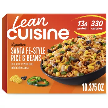 A box of Santa-Fe Style Rice and Beans with the Protein Kick label near a bowl of rice, beans, corn and sour cream.