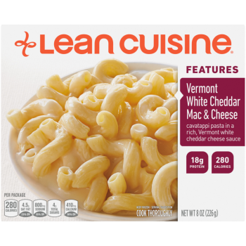 A box of Vermont White Cheddar Mac and Cheese with a features label near a bowl of macaroni with Vermont cheddar sauce.