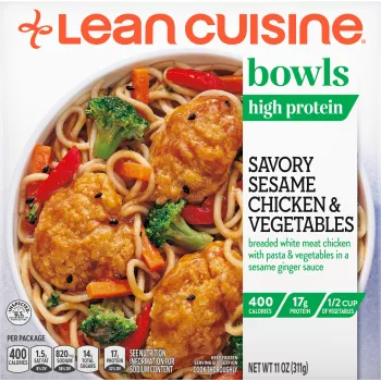 A box of Savory Sesame Chicken and Vegetables with the green bowls label near a bowl of noodles and sesame chicken.