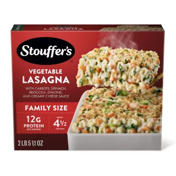 Box of Veggie Lovers Lasagna with a plate and dish of lasagna on a table with the product name and "FAMILY SIZE" label.