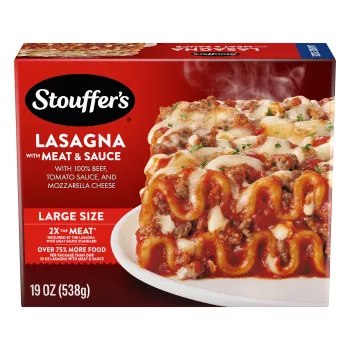 A plate of Lasagna with Meat & Sauce on a table below the product name, Large Size label, and "2x the Meat" label.