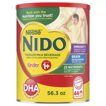 A canister of Nido 1+ with an “immunity, Vitamins A, C, & D, Iron, and Zinc” badge near a young boy clapping.