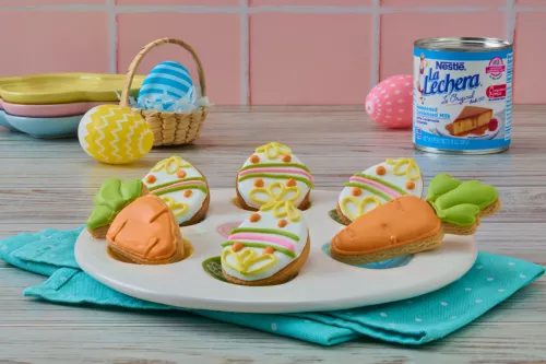 Buttery Easter sugar cookies decorated with colored royal icing, served on a plate