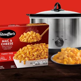 Photograph: Stouffer's Mac &amp; Cheese box, bowl of macaroni, and stainless slow cooker on red