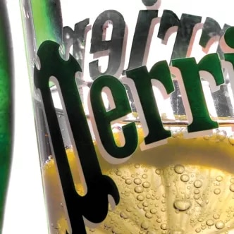 Photograph: Perrier glass and green bottle, lemon slice and bubbles.