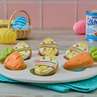 Buttery Easter sugar cookies decorated with colored royal icing, served on a plate