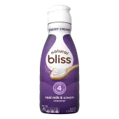 White bottle of natural bliss Sweet Cream flavored Creamer with a purple label above a spoon of sugar and swirl of milk.