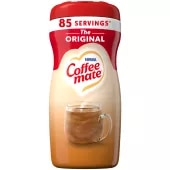 A canister of Original Powder Creamer with a red cap and red label above a mug and biscotti.