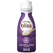 White bottle of natural bliss Sweet Cream flavored Creamer with a purple label above a spoon of sugar and swirl of milk.