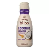 Una botella beige de creamer Coconut Sweet Creme de natural bliss con una etiqueta morada encima del nombre del producto y un coco.
