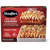 Box of Meat Lovers Lasagna with a plate of lasagna near a dish, the product name, STOUFFER'S logo and "FAMILY SIZE" label.